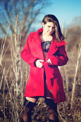 Brunette woman in red coat with underwear outdoor