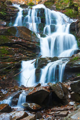 Fototapeta na wymiar Waterfalls on Rocky Autumn Stream