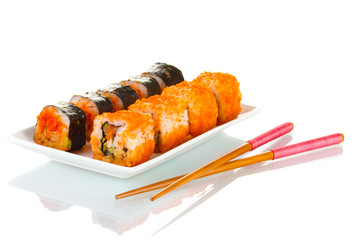 delicious sushi on plate and chopsticks isolated on white