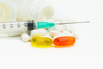 Pills, syringe and bottle. Aspirin day and night
