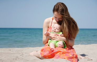 mother and baby on beach