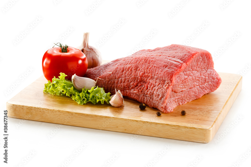 Wall mural raw beef on cutting board on white background