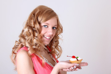 Happy woman with little cake in hand