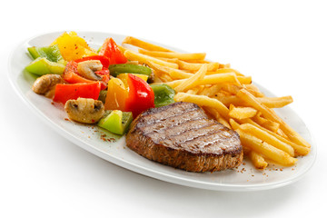 Grilled steak, French fries and vegetables