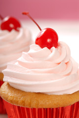 Vanilla cupcake with maraschino frosting and cherry