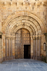 Fototapeta na wymiar Open Old Church Door with Stone Arches and Columns