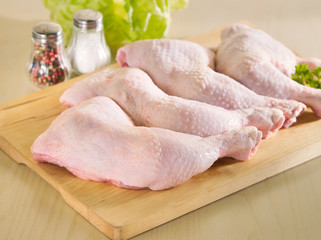 Fresh raw chicken legs arrangement on kitchen board