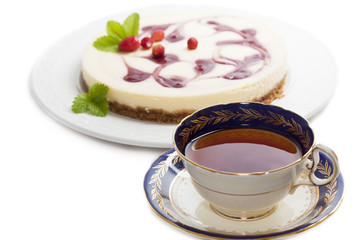 A cup of tea with cheesecake
