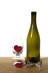 WIne bottle on a table with glasses and hearts