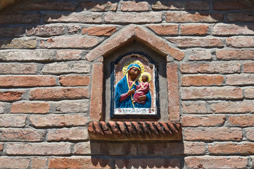 Religious icon in a wall niche.