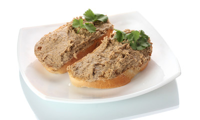 Fresh pate on bread on white plate isolated on white