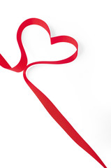 Red ribbon shaped as a heart isolated on white