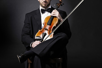 an elegant violinist with his violin