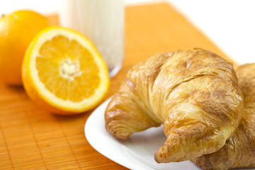 Healthy breakfast with croissants,orange and milk