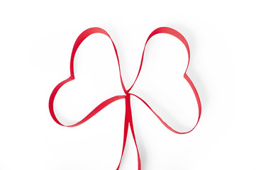 Red ribbon shaped as a heart isolated on white