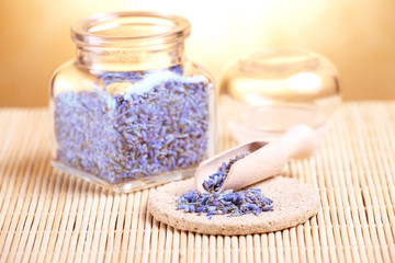 Fototapeta na wymiar Dried lavender petals on the wooden spoon