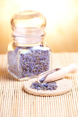 Obraz na płótnie Canvas Dried lavender petals on the wooden spoon