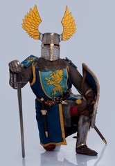 Medieval knight standing on his knee.