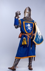 Medieval knight on grey background.