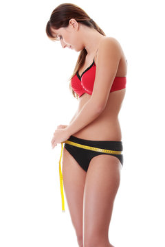 Woman measuring perfect shape of beautiful body.