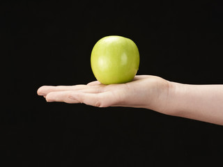 Childs hand with apple in palm