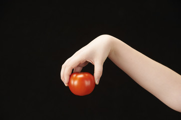 Childs hand with tomatoe