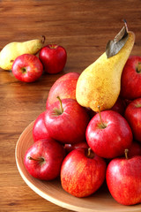 Nice red apples and pear on bowl