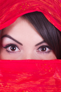 Beautiful girl is posing in red yashmak