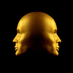 Two-faced gold head statue