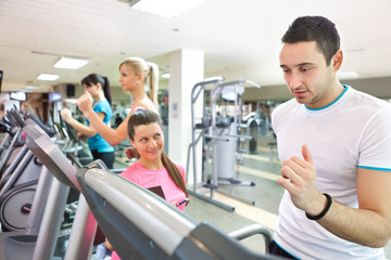 Fototapeta premium trainer instructing man on treadmill