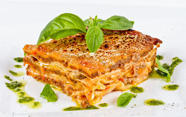 Closeup of lasagna and basil fork