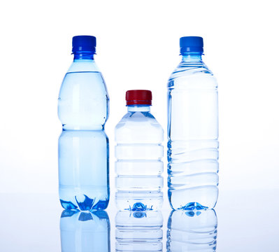 three Bottles water over a white background