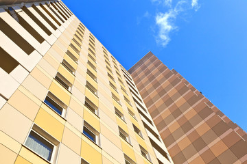 facade of skyscraper with apartments with blue sky