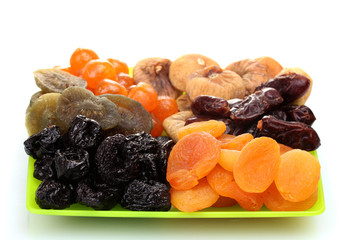 delicious dried fruits on plate isolated on white