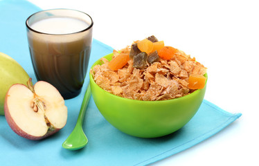 tasty cornflakes in green bowl, apples and glass of milk