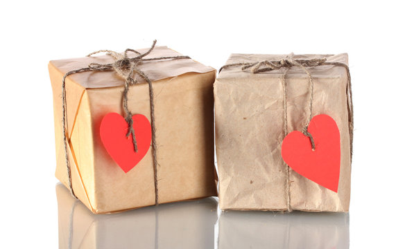 Two small parcels with blank heart-shaped labels isolated