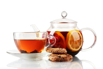 Black fruit tea in glass teaopot and cup isolated on white