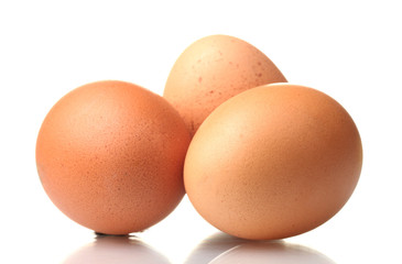 three brown eggs isolated on white