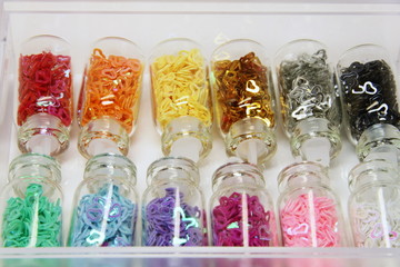 Multicolored jars with decorative hearts in box