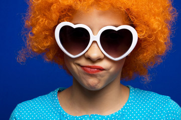 Young girl with orange party wig