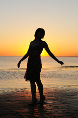 Portrait of young woman as silhouette by the sea