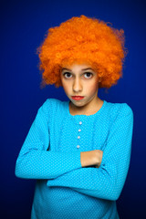 Beautiful young girl with curly orange hair