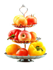 peppers, tomato, orange and apple on a vase isolated