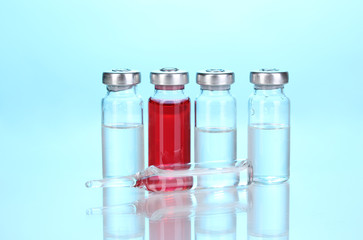 Medical ampoules on blue background