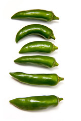 Green chilli peppers isolated on a white studio background.