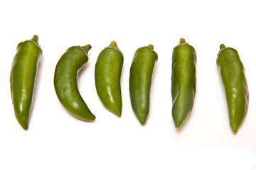 Green chilli peppers isolated on a white studio background.