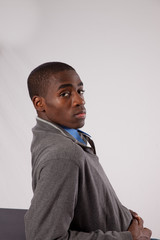 Obraz premium Handsome black man in sweater and tie with eye contact