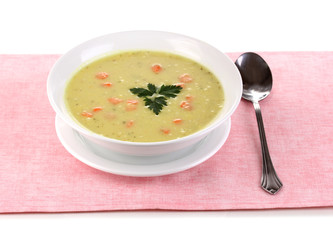 Tasty soup on pink tablecloth isolated on white