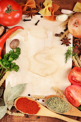 old paper for recipes and spices on wooden table