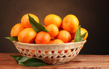 tangerines with leaves in a beautiful basket